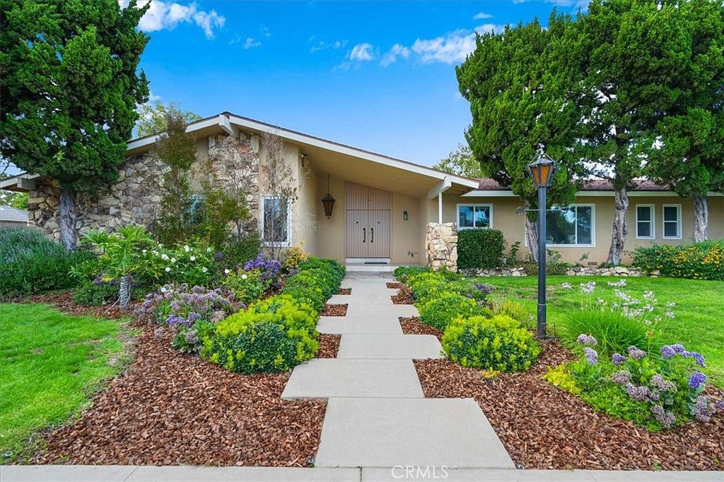 Stone-clad facade and double front doors of 18931 Mayall St, a single-story California ranch in Northridge
